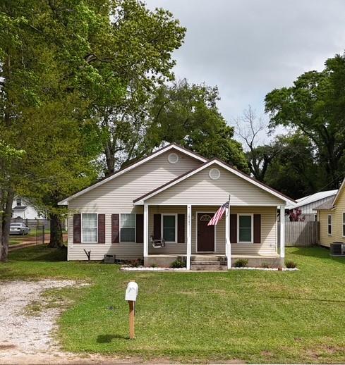 18141 Pennsylvania St, Robertsdale, AL 36567 - bungalow-style home with a front yard, a porch, fence, and cooling unit