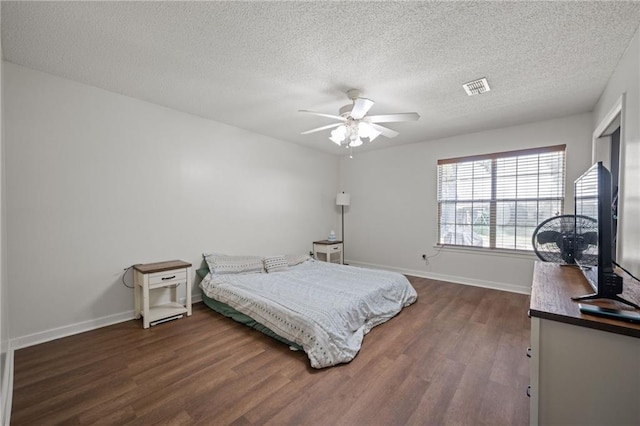 18141 Pennsylvania St, Robertsdale, AL 36567 - bedroom featuring visible vents, baseboards, a textured ceiling, and dark wood-style floors
