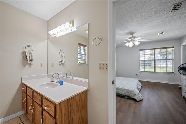 18141 Pennsylvania St, Robertsdale, AL 36567 - bathroom featuring vanity, baseboards, a ceiling fan, visible vents, and wood finished floors