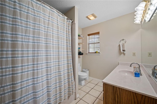 18141 Pennsylvania St, Robertsdale, AL 36567 - full bathroom with a textured ceiling, vanity, tile patterned flooring, toilet, and baseboards