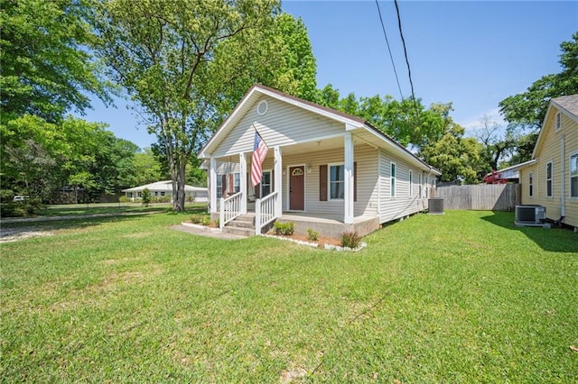 18141 Pennsylvania St, Robertsdale, AL 36567 - bungalow-style house with covered porch, a front yard, fence, and central AC