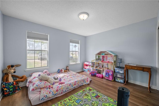 18141 Pennsylvania St, Robertsdale, AL 36567 - bedroom with a textured ceiling, baseboards, and wood finished floors