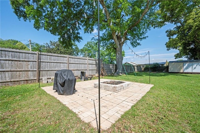 18141 Pennsylvania St, Robertsdale, AL 36567 - view of yard featuring a fire pit, a patio area, a fenced backyard, a storage shed, and an outbuilding