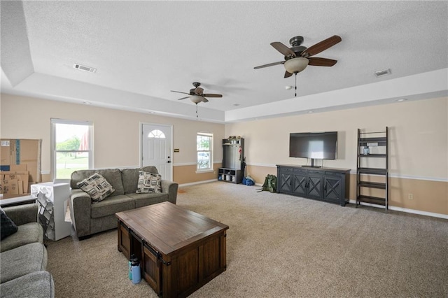 18141 Pennsylvania St, Robertsdale, AL 36567 - living room featuring visible vents, baseboards, a raised ceiling, and a textured ceiling