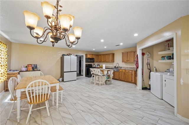 18141 Pennsylvania St, Robertsdale, AL 36567 - dining space with separate washer and dryer, marble finish floor, a notable chandelier, and recessed lighting