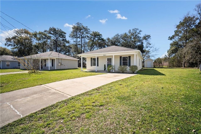 view of front facade featuring an outdoor structure, concrete driveway, and a front yard