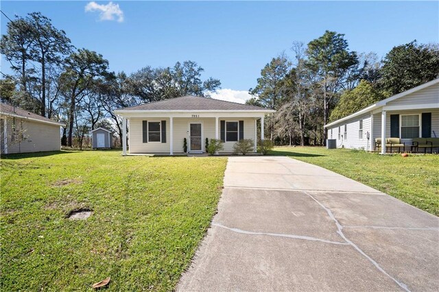 view of front of home with driveway, covered porch, an outbuilding, and a front lawn