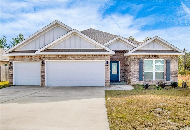 craftsman house with a garage and a front lawn