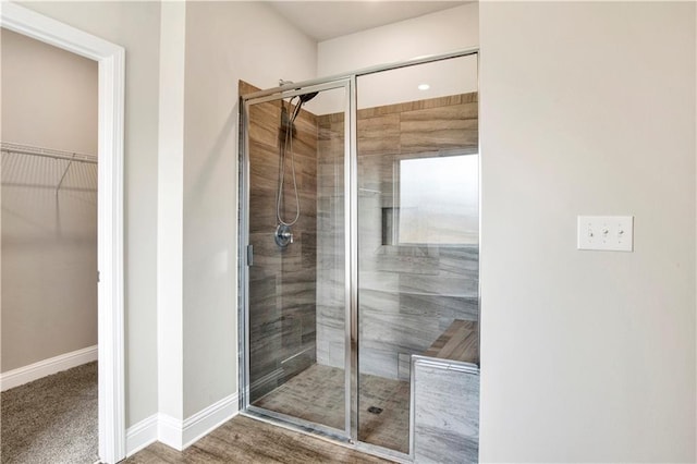 bathroom featuring hardwood / wood-style flooring and walk in shower