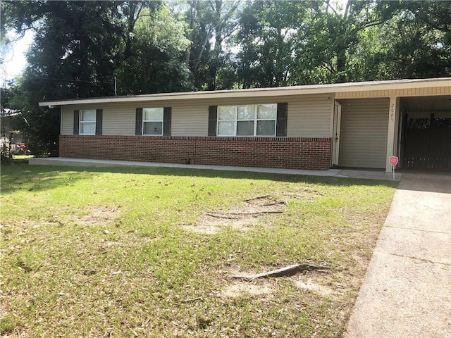 single story home with brick siding, a carport, a front yard, and concrete driveway