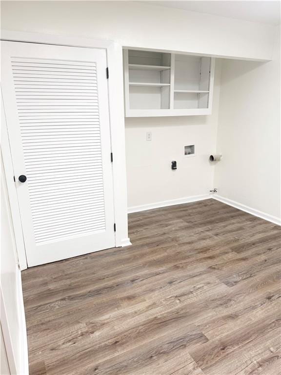 laundry room with washer hookup, baseboards, laundry area, and wood finished floors