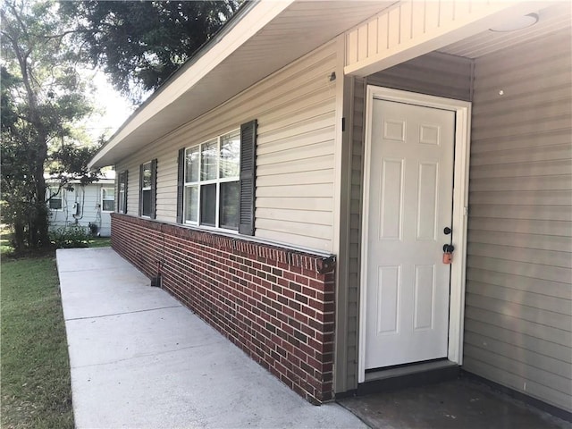 property entrance with brick siding