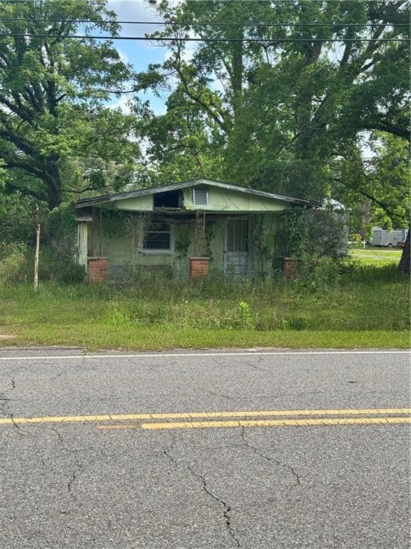 bungalow-style house with concrete block siding
