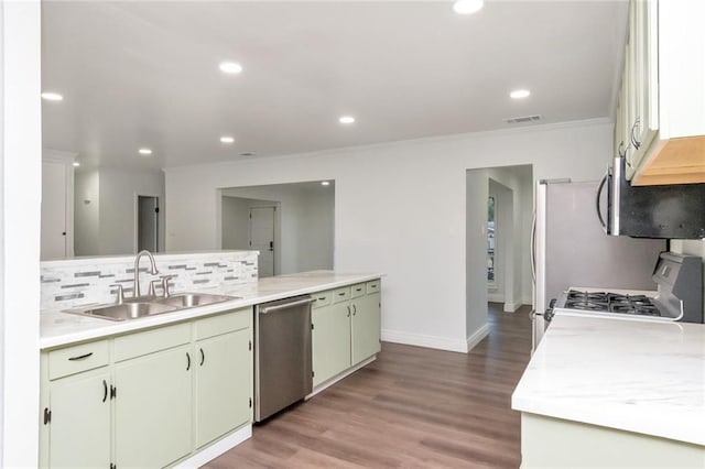 kitchen with light hardwood / wood-style flooring, backsplash, ornamental molding, sink, and appliances with stainless steel finishes