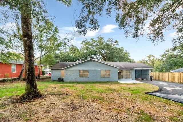 back of house with a lawn