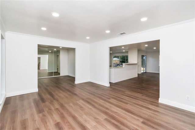 interior space with crown molding and dark hardwood / wood-style flooring