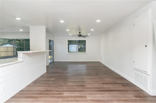 unfurnished living room featuring ceiling fan and hardwood / wood-style flooring