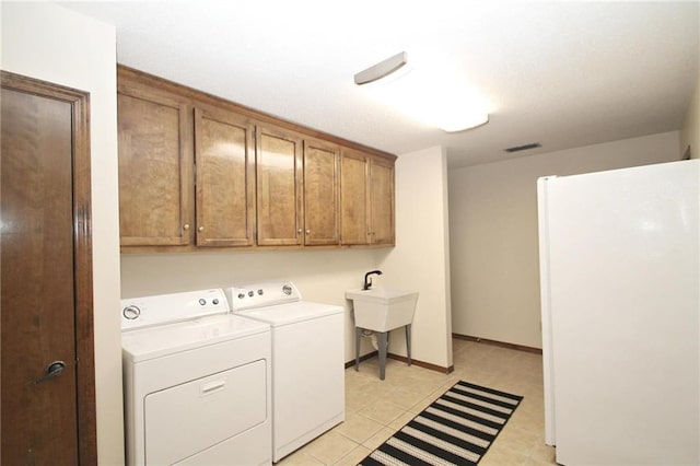 106 Windsor Ct, Daphne, AL 36526 - laundry area with cabinet space, separate washer and dryer, and light tile patterned flooring