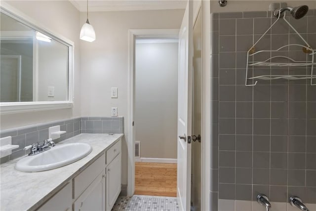 bathroom with vanity, tasteful backsplash, and hardwood / wood-style flooring