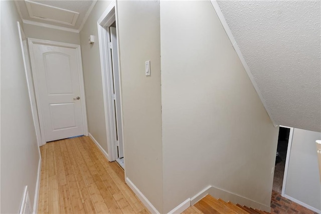 hall featuring a textured ceiling and light wood-type flooring