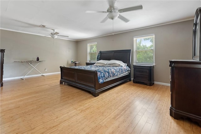 bedroom featuring light hardwood / wood-style floors, multiple windows, and ceiling fan