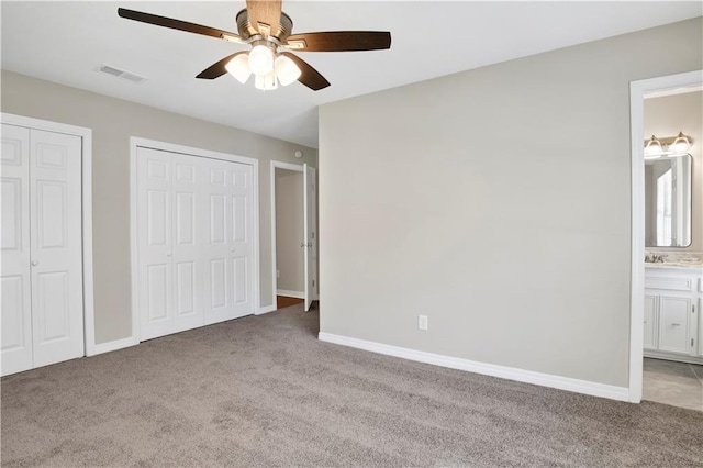2604 Old Dobbin Dr E, Mobile, AL 36695 - unfurnished bedroom with carpet, multiple closets, ensuite bathroom, and ceiling fan
