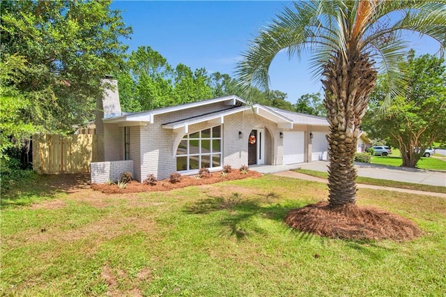 2604 Old Dobbin Dr E, Mobile, AL 36695 - mid-century home with a chimney, brick siding, an attached garage, and driveway