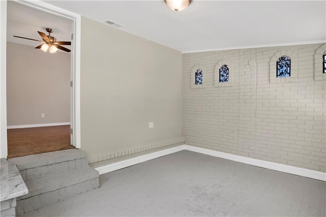 2604 Old Dobbin Dr E, Mobile, AL 36695 - empty room with brick wall and a ceiling fan