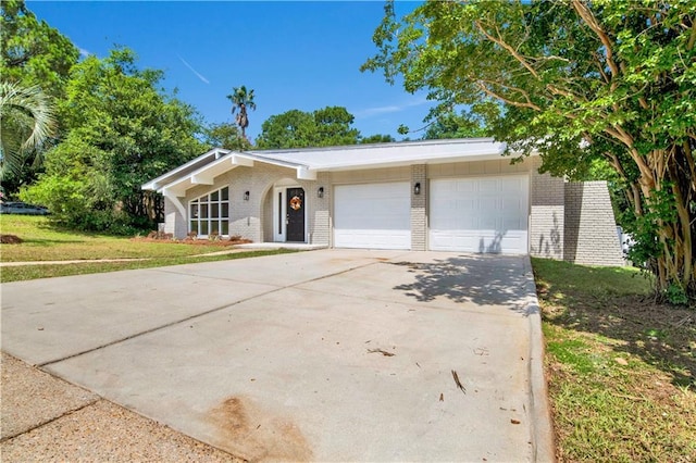 2604 Old Dobbin Dr E, Mobile, AL 36695 - view of front of house featuring brick siding, an attached garage, driveway, and a front yard