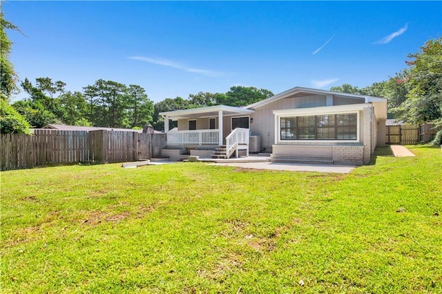 2604 Old Dobbin Dr E, Mobile, AL 36695 - rear view of house with a fenced backyard and a patio area