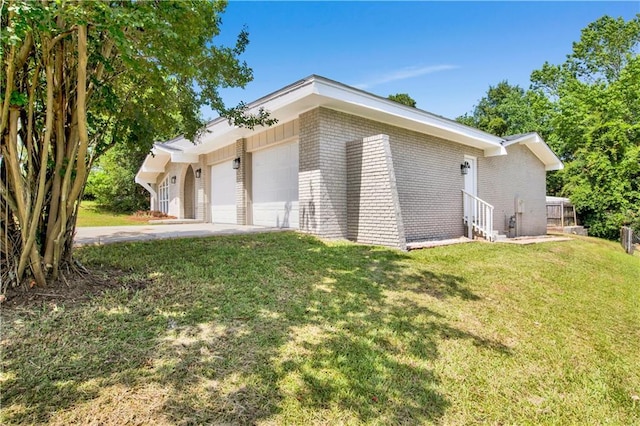 2604 Old Dobbin Dr E, Mobile, AL 36695 - view of property exterior featuring brick siding, a garage, entry steps, a yard, and driveway