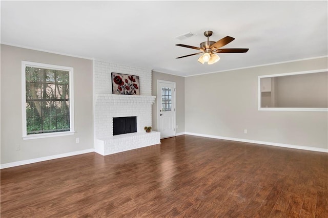 2604 Old Dobbin Dr E, Mobile, AL 36695 - unfurnished living room featuring a ceiling fan, wood finished floors, ornamental molding, and a brick fireplace