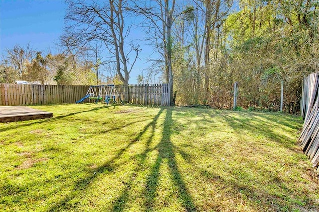 view of yard featuring a fenced backyard and a playground