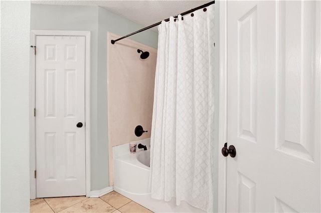 bathroom with a textured ceiling, shower / bath combination with curtain, and tile patterned floors