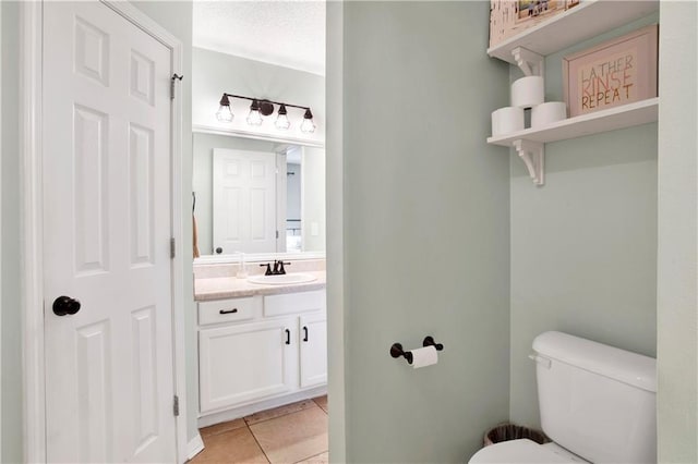 bathroom featuring vanity, toilet, and tile patterned floors