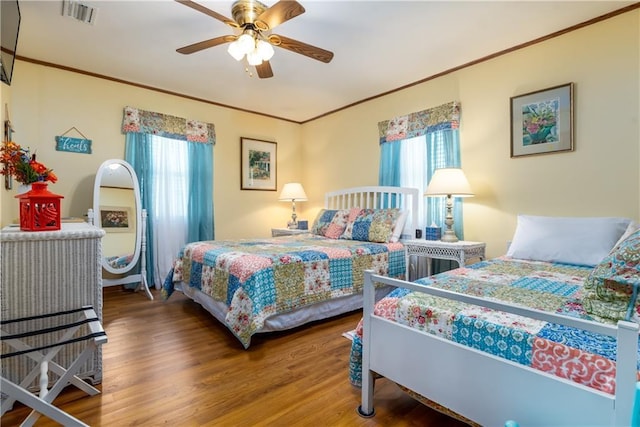 2012 Bienville Blvd, Dauphin Island, AL 36528 - bedroom with wood finished floors, crown molding, and a ceiling fan