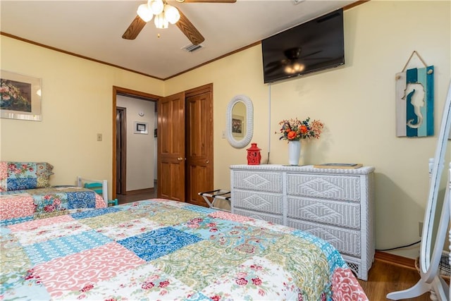 2012 Bienville Blvd, Dauphin Island, AL 36528 - bedroom with wood finished floors, a ceiling fan, and crown molding
