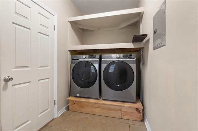 285 Portside Blvd, Mobile, AL 36695 - laundry area featuring washer and clothes dryer, light tile patterned floors, baseboards, and electric panel