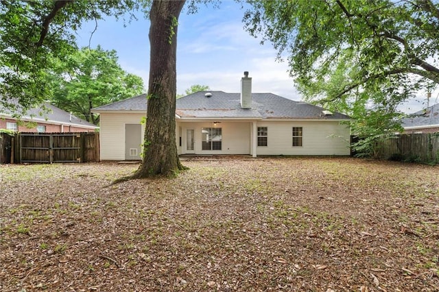 285 Portside Blvd, Mobile, AL 36695 - back of house with a fenced backyard and a chimney