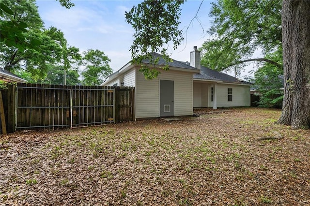 285 Portside Blvd, Mobile, AL 36695 - rear view of house with fence and a chimney
