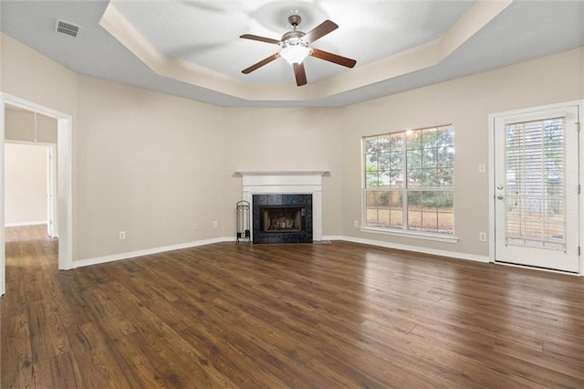 285 Portside Blvd, Mobile, AL 36695 - unfurnished living room with a raised ceiling, dark wood-style floors, and healthy amount of natural light