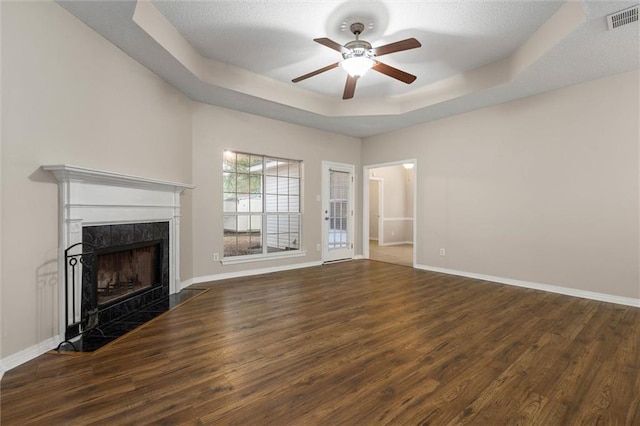 285 Portside Blvd, Mobile, AL 36695 - unfurnished living room with a ceiling fan, a tray ceiling, wood finished floors, and a high end fireplace