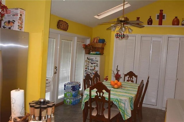 dining area featuring ceiling fan and dark tile patterned floors