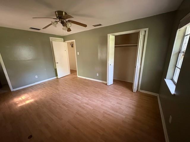 3515 York Rd, Mobile, AL 36605 - unfurnished bedroom featuring wood finished floors, baseboards, a closet, and ceiling fan