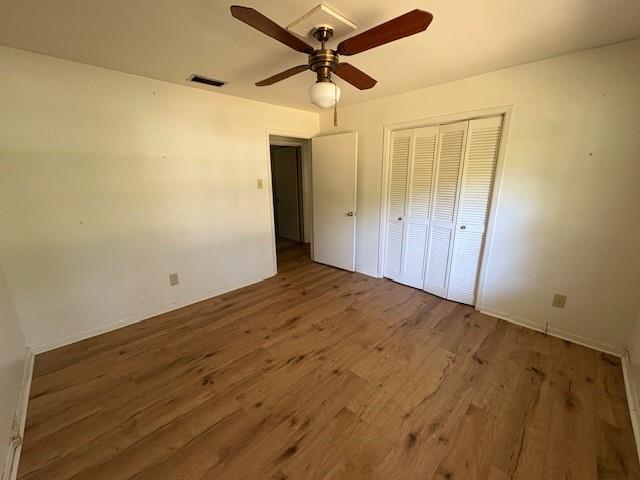 3515 York Rd, Mobile, AL 36605 - unfurnished bedroom featuring wood finished floors, a closet, and ceiling fan