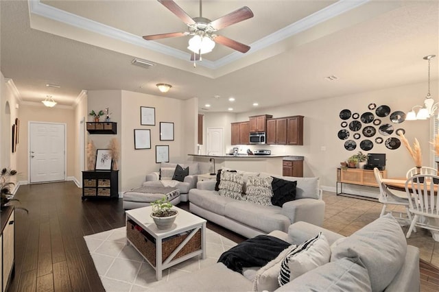 6120 Whitebark Dr, Mobile, AL 36693 - living room featuring a tray ceiling, crown molding, ceiling fan, recessed lighting, and dark wood-style flooring