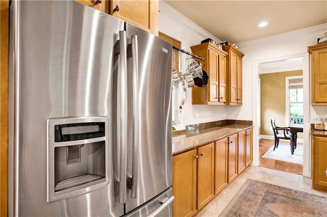 24795 Austin Rd, Daphne, AL 36526 - kitchen with stainless steel fridge, dark stone countertops, brown cabinets, recessed lighting, and baseboards