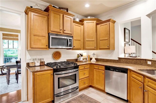 24795 Austin Rd, Daphne, AL 36526 - kitchen with appliances with stainless steel finishes, crown molding, light stone countertops, recessed lighting, and light tile patterned floors
