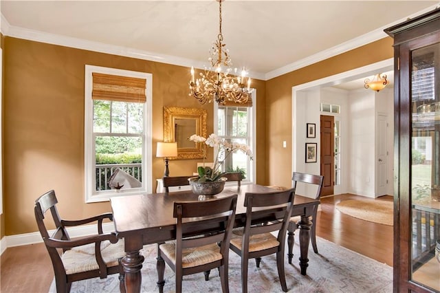 24795 Austin Rd, Daphne, AL 36526 - dining space featuring healthy amount of natural light, wood finished floors, a chandelier, baseboards, and crown molding