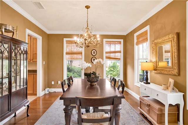 24795 Austin Rd, Daphne, AL 36526 - dining room featuring a chandelier, dark wood-type flooring, ornamental molding, and baseboards